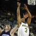 Michigan freshman Trey Burke attempts a shot around Northwestern senior John Shurna in the second half against Northwestern at Crisler Center on Wedensday. Melanie Maxwell I AnnArbor.com